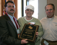 Jeff Wainwright, (left) of the GA Peach Council and Larry Yonce (right) representing the SC Peach Council present Janice Whitaker (center) with the 2009 Mrs. Peach Award